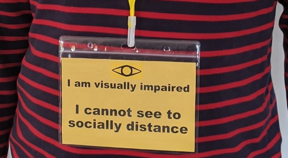 Close up of visually impaired awareness badge