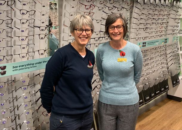 iSightCornwall Low Vision Advisor Louise (right) poses with Camborne Specsavers manager Jo Palmer in front of a display of glasses.