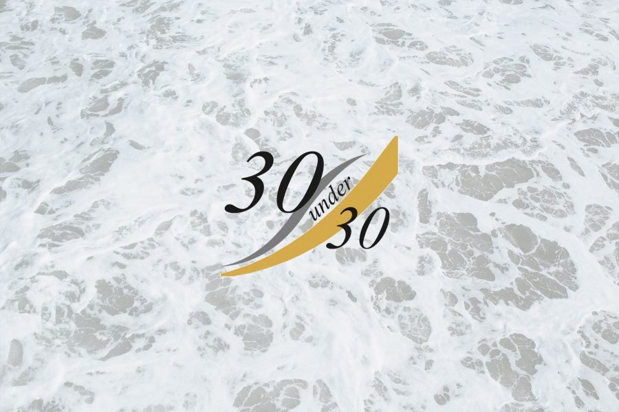 Cornwall's '30 Under 30' logo on a background of white foam on a beach.
