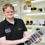 Dominc Hall, Customer Services Officer at iSightCornwall demonstrates a giant calculator.