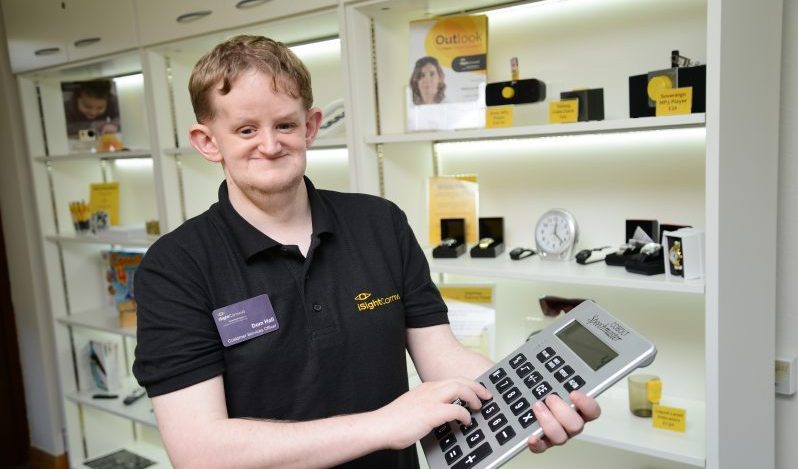 Dominc Hall, Customer Services Officer at iSightCornwall demonstrates a giant calculator.