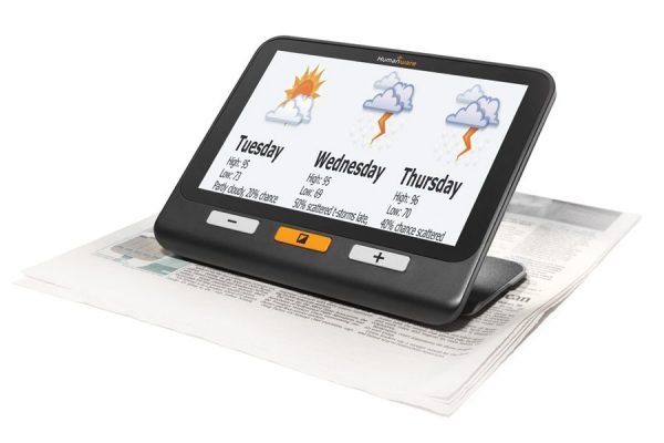 The Explore 8 handheld video magnifier. The weather forecast from a newspaper can be seen displayed on the magnifier screen.