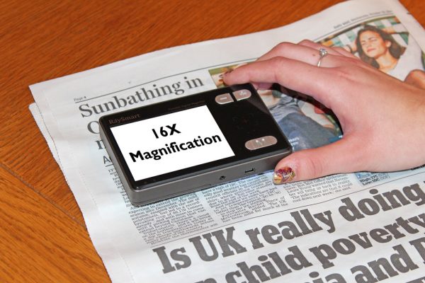 The HandyReader HD being used to magnify a newspaper.