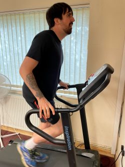 Hoby runs on a treadmill in his home as part of his marathon preparations 