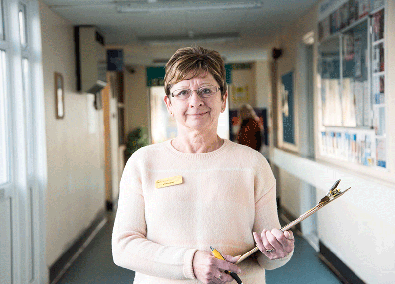 An iSightCornwall hospital desk volunteer at St Austell Hospital