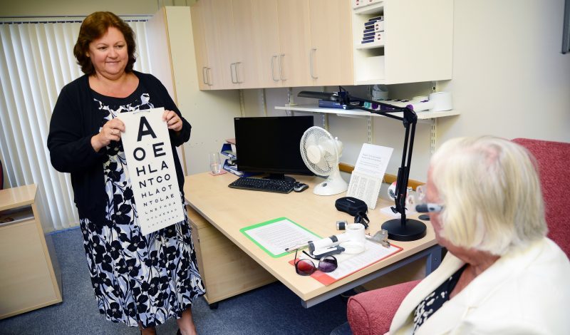 Linda from our Low Vision department performing a Low Vision test with one of our Members