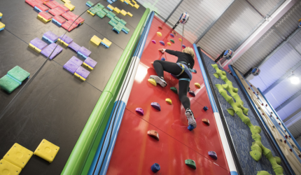 iSightCornwall member, Claire climbs the multi coloured climbing wall.