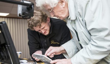 iSightCornwall team member, Dominic demonstrates an electronic magnifier to a client.