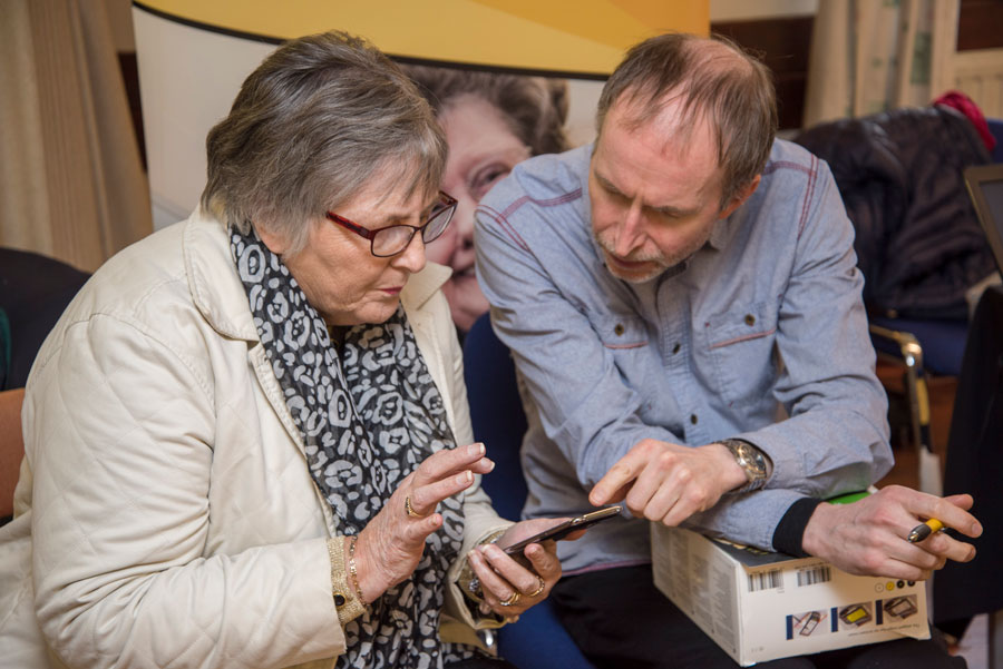 iSightCornwall Assistive Technology Officer, Rod Keat demonstrates a specially adpated mobile phone to a client.