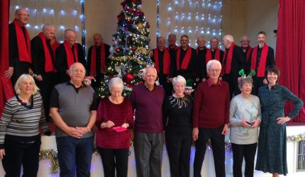 Photo shows Shirley (fourth from the right in a black jumper) with friends and supporters at the Saltash BAPS celebration in December 2019
