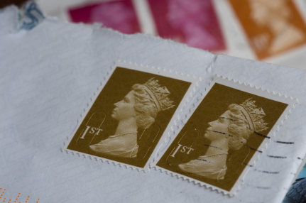 British first class stamps on white envelopes.